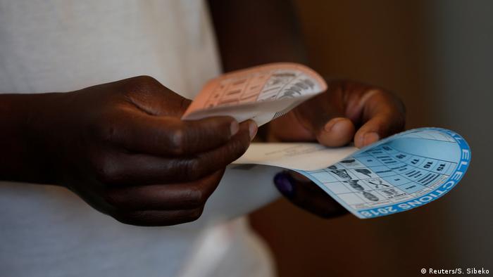 Hands holding ballot papers in Zimbabwe (Reuters/S. Sibeko)