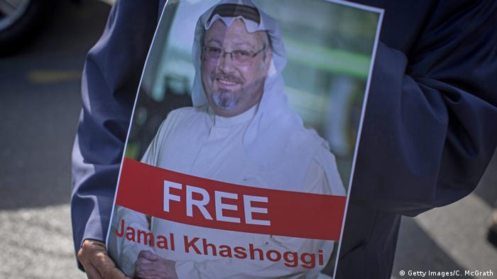 A man holds a poster of Saudi journalist Jamal Khashoggi during a protest 