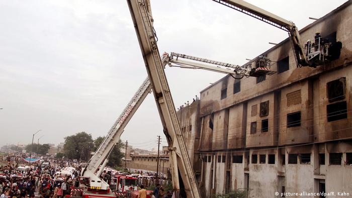 Cranes lift investigators to upper floor of a burned out factory (picture-alliance/dpa/R. Kahn)