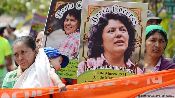 Women hold up pictures of murdered environmental activist Berta Caceres during a demonstration in Honduras 