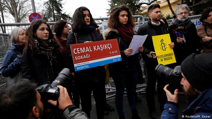 Amnesty International demonstrator hold up signs outside the barricaded Saudi Arabia Consulate in Istanbul to mark 100 day since the killing of journalist Jamal Khashoggi (Reuters/M. Sezer)