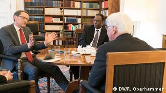 Ludger Schadomsky, Mohammed Negash and Frank-Walter Steinmeier sit around a table talking