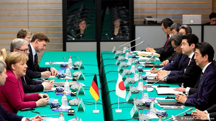 German Chancellor Angela Merkel speaks to Japanese Prime Minister Shinzo Abe at the start of their meeting at Abe's official residence in Tokyo (Reuters/F. Robichon)