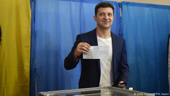 Ukrainian comedian and presidential candidate Volodymyr Zelensky shows his ballot to the media at a polling station during the second round of Ukraine's presidential election in Kiev