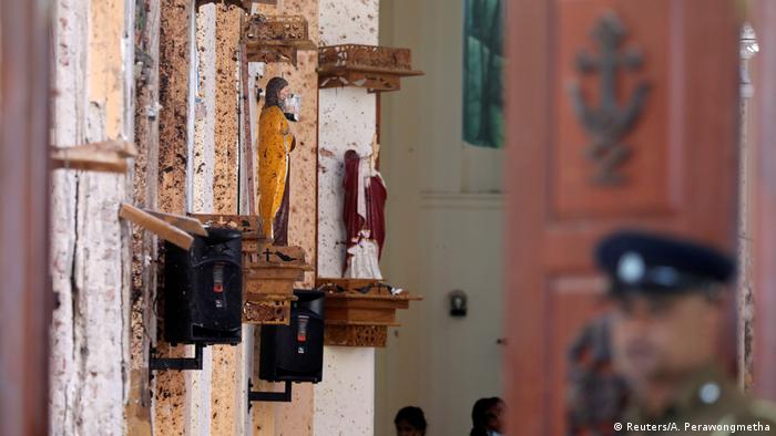 Police officers work at the scene at St. Sebastian Catholic Church in Negombo (Reuters/A. Perawongmetha)