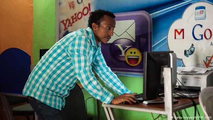 A man in Ethiopia works on a computer in an internet cafe (photo: SOLAN KOLLI/AFP/Getty Images)