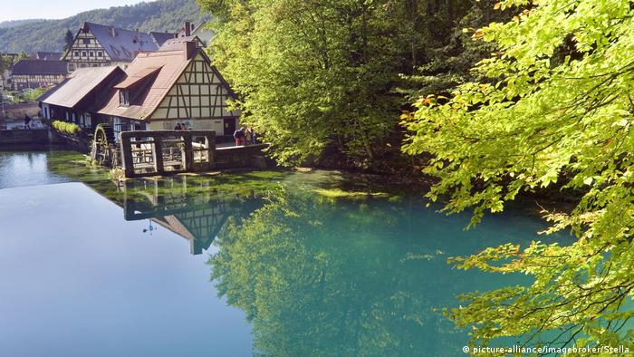 Blautopf lake with timber-framed water mill in Blaubeuren, Baden-Württemberg