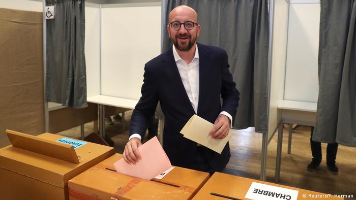Belgian Prime Minister Charles Michel prepares to cast his vote for the Belgian general and regional elections and for the European Parliament Elections in Limal (Reuters/Y. Herman)