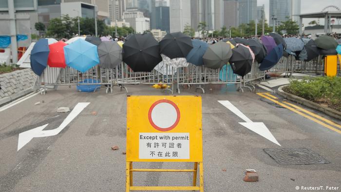 Umbrellas on a police barricade