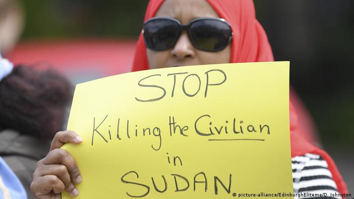 A Sudanese protester in Edinbugh holds up a poster reading Stop killing civilans in Sudan (picture-alliance/EdinburghEliteme/D. Johnston)