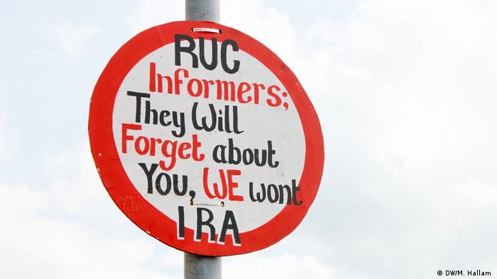 Derry, Londonderry, 02.08.2019: An imitation road sign, erected near the site of investigative journalist Lyra McKee's murder on Creggan Estate in Derry, Londonderry. It reads: RUC [Royal Ulster Constabulary, Northern Ireland's police force] informers; They will forget about you, We won't, IRA [Irish Republican Army]. 