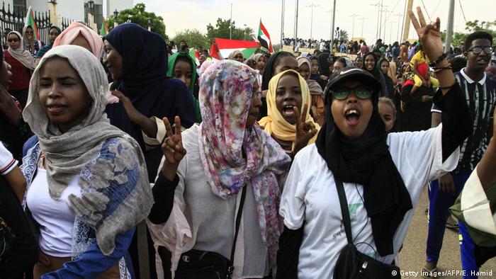 People of Sudan celebrate after a transitional constitution is signed to pave way for civilian rule