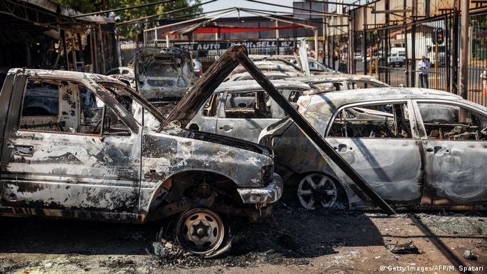 Dozens of burnt-out cars litter a car dealership in Jonannesburg