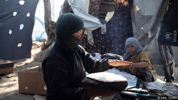 A woman in a refugee camp making bread