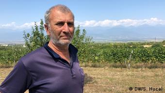 Georgian winemaker poses for a picture in his vineyard in Georgia's eastern Kakheti region.