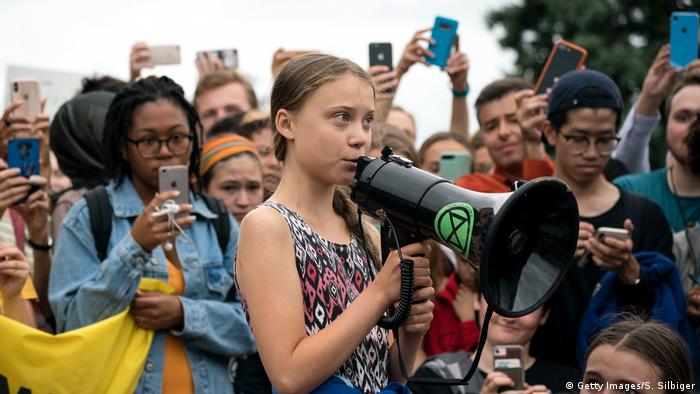 Teenage Swedish climate activist Greta Thunberg delivers brief remarks surrounded by other student environmental advocates in Washington. 