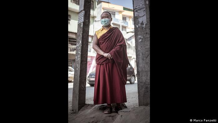 Buddhist monk wearing facemask against air pollution in Kathmandu, Nepal