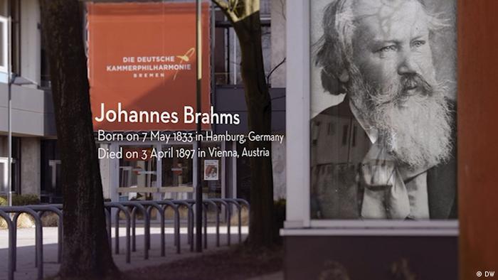 Poster of the bearded old Brahms with his birth and death dates (DW)