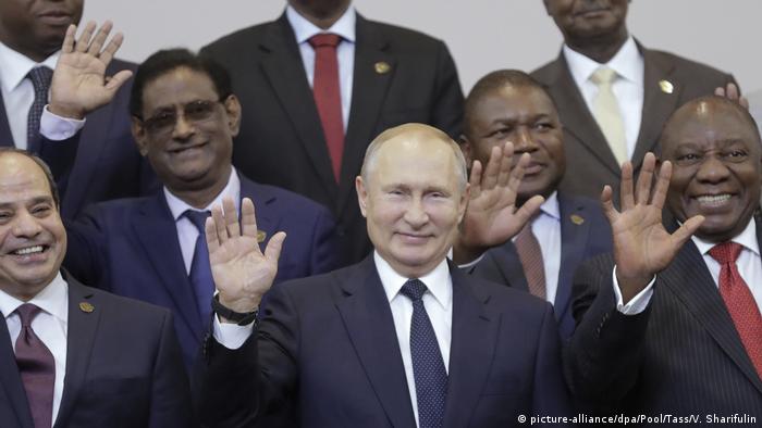 Russian President Vladimir Putin stands amid African heads of state