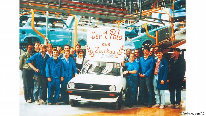 A espaldas de los trabajadores se siguen construyendo los Trabants. Los empleados presentan el primer Volkswagen Polo fabricado en Zwickau en mayo de 1990.
