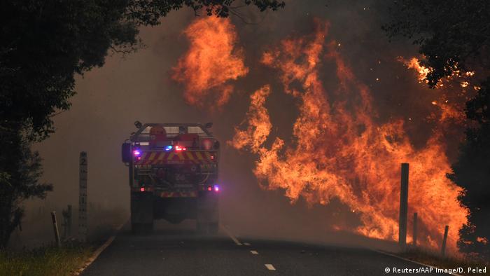 A fire truck is seen near a bushfire in Nana Glen