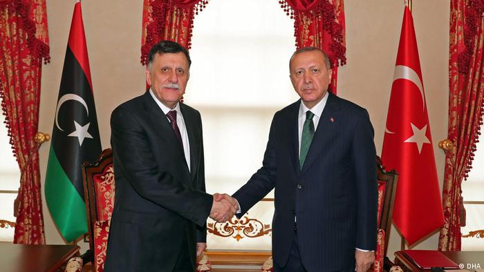 Presidente turco, Erdogan, e premiê da Líbia, Fayez al-Sarraj, em aperto de mão