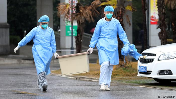 Chinese medical staff carry a box outside a hospital (Reuters/Str)