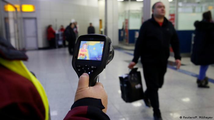 Kazakh sanitary-epidemiological service worker uses a thermal scanner to detect travellers from China who may have symptoms possibly connected with the previously unknown coronavirus, at Almaty International Airport, Kazakhstan January 21, 2020. REUTERS/Pavel Mikheyev