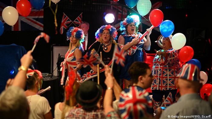 A band plays as Brexit supporters wave Union flags