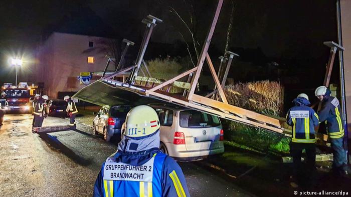 A carport blown over onto two vehicles in Germany by winter storm Sabine