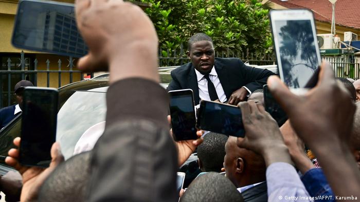 Residents of Nairobi pose for selfies with Nairobi senator Sakaja Johnson in 2019. 