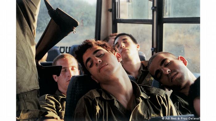 Young soldiers sleeping in a bus, one with his head on another's shoulder (Adi Nes & Praz-Delavallade Paris)