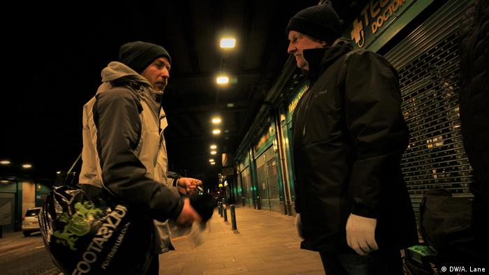 A homeless man and an aid volunteer in Glasgow
