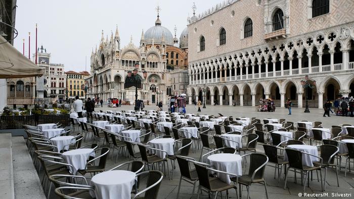 Empty tables are pictured outside a restaurant at St Mark's Square in Venice, Italy