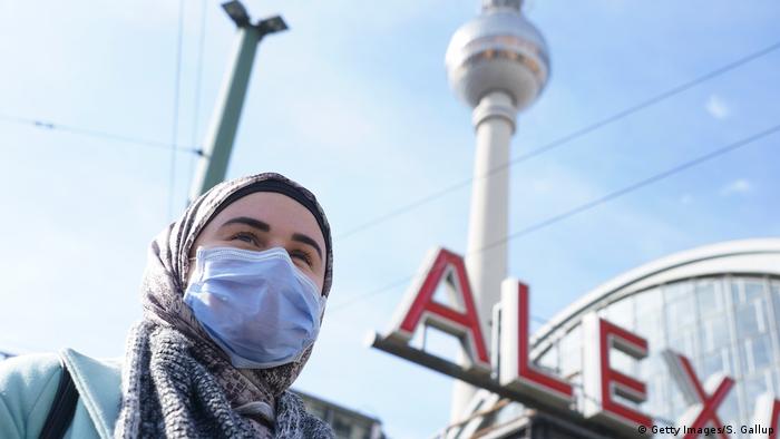 A person at Berlin's Alexanderplatz wearing a face mask (Getty Images/S. Gallup)