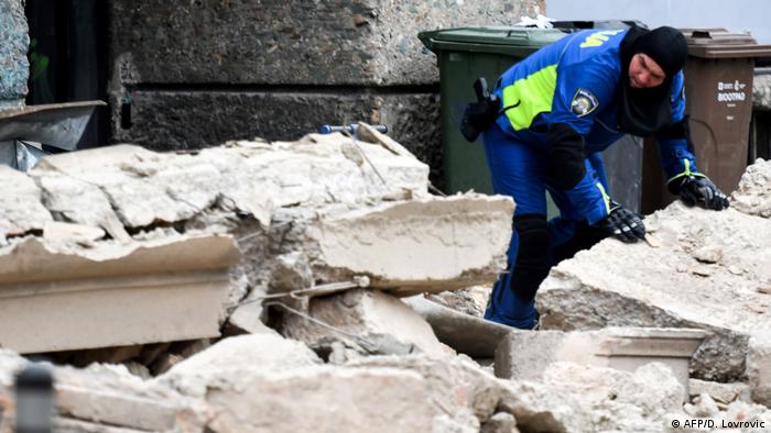 A police officer moving rubble after an earthquake in Zagreb on Sunday (AFP/D. Lovrovic)