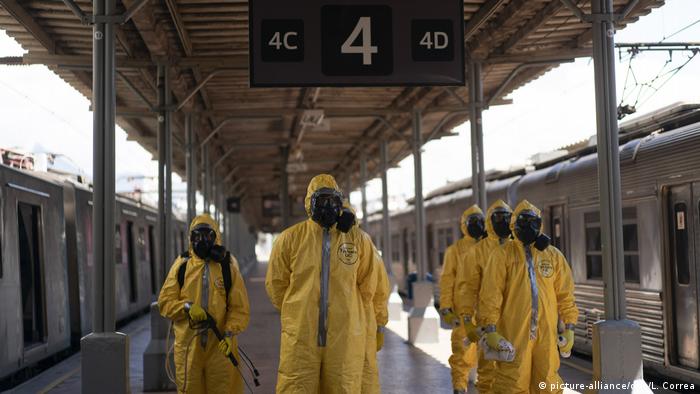 Soldiers in hazmat suits prepare ready for working disinfecting Rio de Janeiro's main train station 
