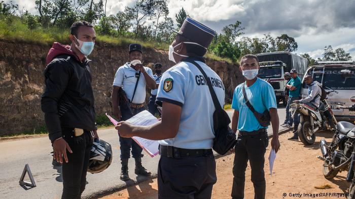 Madagascar police inspect papers at a traffic road block. (Getty Images/AFP/Rijasolo)