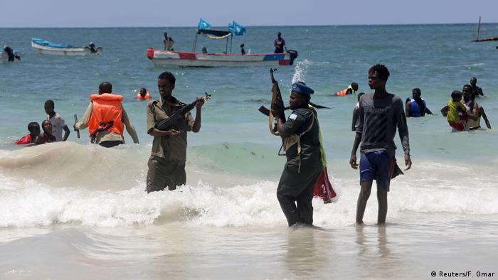 Police attempt to disperse swimmers on a Somalian beach (Reuters/F. Omar)