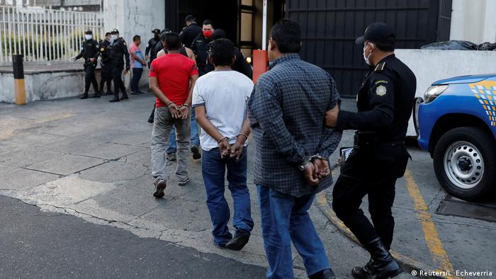 Guatamalan police escorting detained persons (Reuters/L. Echeverria)
