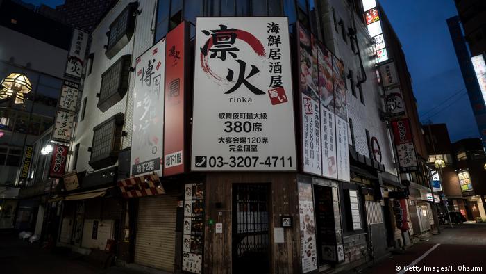 Closed restauraunts in a darkened and quiet streets in Japan's Kabukicho entertainment area