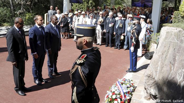 French President Emmanuel Marcon, Guinean President Alpha Conde (left) and Ivory Coast President Alassane Ouattara (right) remember fallen soldiers at a 2019 ceremony in Provence marking WWII 