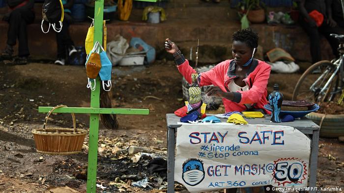 A woman in Kenya sells handmade masks during the coronavirus pandemic (Getty Images/AFP/T. Karumba)