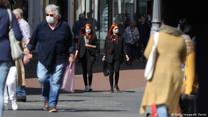 Shoppers take to the streets in Bonn, North Rhine-Westphalia, after Germany allowed stores under 800 square meters to open in a loosening of coronavirus lockdown restrictions. Some shoppers are wearing facemasks.