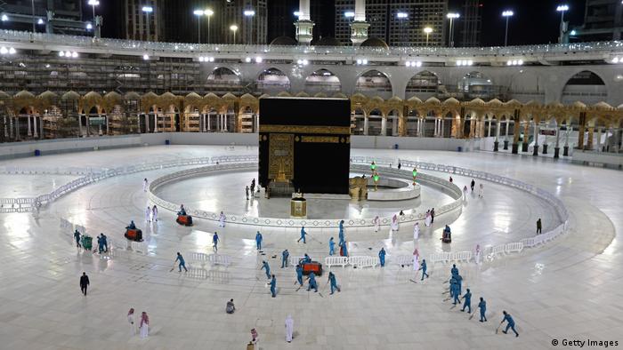 Sanitation workers disinfecting the area around the Kaaba in Mecca's Grand Mosque as a result of the coronavirus pandemic