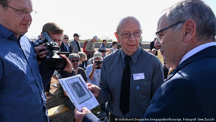 Karl Cramm shows a photo of his father at the Rossoschka German War Cemetery