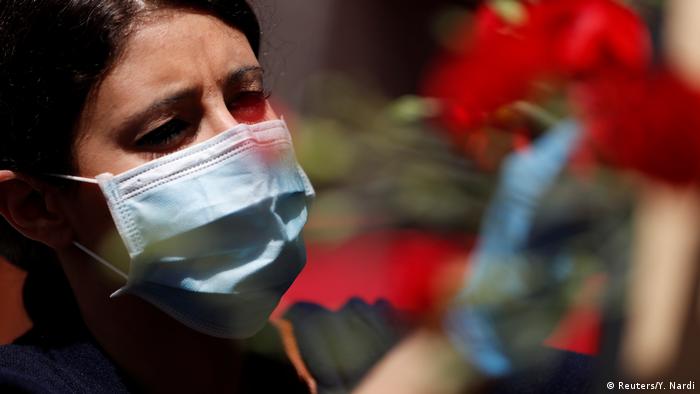 A female worker in Italy wearing a mask (Reuters/Y. Nardi)