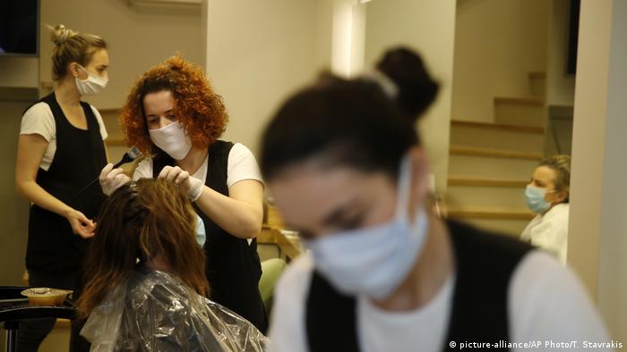 Hairdressers colour ladies' hair in a salon in Athens, Greece. 