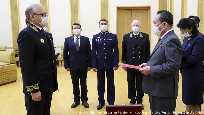 In this photo released by Russian Embassy in the DPRK/Russian Foreign Ministry Press Service on Tuesday, May 5, 2020, Russian Ambassador to Democratic People's Republic of Korea Alexander Matsegora, left, and Democratic People's Republic of Korea Foreign Minister Ri Son-gwon, foreground right, both wearing face masks to protect against coronavirus, attend a ceremony of awarding North Korean leader Kim Jong-un with Russia's 75th anniversary Victory medal for his major contribution in commemorating Soviet soldiers, who died in 1945 during Korea's liberation, at the Mansudae Palace of Congress in Pyongyang, North Korea. (picture-alliance/AP/Russian Foreign Ministry Press Service/Russian Embassy in the DPRK)