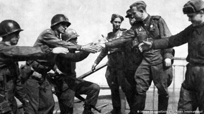 Soviet and American troops meet at the River Elbe, near Torgau in Germany